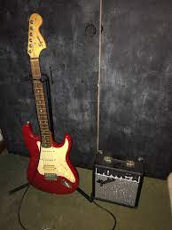 Used Red Squire Stratocaster With New Fender Frontman 10g Amplifier Comes With Amp Cord And Guitar Stand With Brand N Red Electric Guitar Guitar Stand Guitar