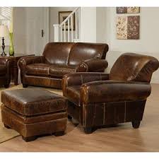 Large brown leather chair and cushioned ottoman made with 100% cow leather, teak wood, and individual nail heads. I Will Have My Chair Ottoman Family Room Furniture Cheap Dining Room Chairs World Market Dining Chairs