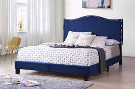 Perfect for drifting off to sleep in a glamorous space, this bed features a head and footboard with a carved silhouette wrapped in velvet upholstery. Skye Upholstered Panel Bed Blue Velvet Full With Solid Wood Legs Nailhead Headboard Footboard Rails Slats Pilaster Designs