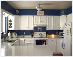 cream kitchen cabinets with blue walls