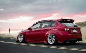 Always be a safe driver and respect the rules of the road. Hd Wallpaper Red Subaru 5 Door Hatchback Impreza Wrx Sti Tuning Jdm Car Wallpaper Flare