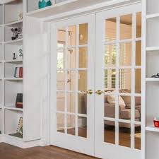Swinging French Doors With Glass Panels Separating A Library From A Living Room French Doors Bedroom Glass Doors Interior Interior Double French Doors