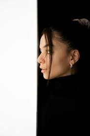 A woman is looking out of a white wall photo