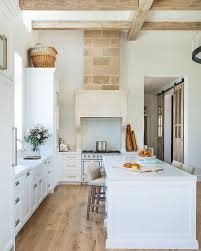 White traditional kitchen featuring black granite countertops and hardwood flooring. Pin On Home Kitchen Dining Room