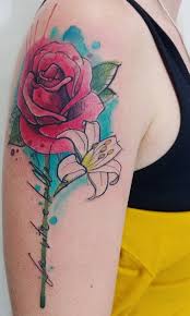 A red rose at the top, followed by a pink rose, the profile of a skull and another flower is depicted below. 42 Amazing Must Have Rose Tattoos This Year Design Ideas 2019 Page 4 Of 42 Tattoo Go Rose Tattoos For Men Rose Tattoos On Wrist Rose Tattoos