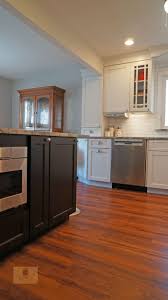 The White Koch Kitchen Cabinets Accented By A Dark Wood Finish Island And Richelieu Hardware Transitional Kitchen Design Kitchen And Bath Design Kitchen Design