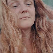 What is the tree with peeling bark and heavy trimming?