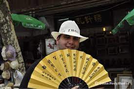 Who Doesn T Love A Man With An Oversized Chinese Fan Cowboy Hats Chinese Places Chinese