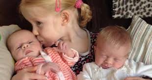 Triplets who were born FOUR YEARS apart as little girl proudly tells  schoolmates: "My sisters were put in the freezer"