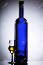 Download A Blue Bottle And A Liquor Glass With Yellow Liquid In It Stock Photo Picture And Royalty Free Image Image 3816177 PSD Mockup Templates