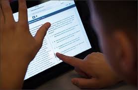 Student utilizing digital tablets to study for competitive exams