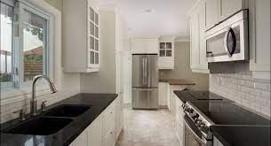 Full high covered wall tiles kitchen backsplash signed by black grouts, white tiles, white kitchen cabinetry tied with black hardware, black island carries the white countertop. Take The Subway Backsplashes For Kitchen Countertops