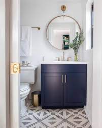 Transitional Powder Room Features Sophisticated Fittings Such As A Navy Blue Vanity Topped With White Blue Bathroom Vanity Powder Room Vanity Bathrooms Remodel