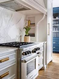 The sleek black marble counters, natural wood cabinets and striking brown brick backsplash set this space apart from other kitchens. 40 Best Kitchen Hood Ideas In 2021 Kitchen Hoods Kitchen Remodel Kitchen Hood Design