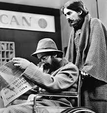 George Harrison Pushes John Lennon In A Wheelchair As They Travel In Unconvincing Disguises Past A Pan American Airline The Beatles Music Print United Artists