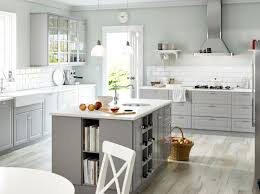Glossy white kitchen cabinets with medium wood finished breakfast counter. White Marble Countertops Kitchen Design Nsg Granite Marble Flooring Cabinets In Houston And Sugar Land