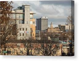 Variety of colorful flowers in the square gardens, carefully tended from season to season Downtown Fayetteville Arkansas Skyline Dickson Street Canvas Print Canvas Art By Gregory Ballos