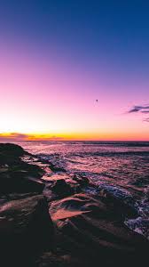 9.this coastal view, made even better by clouds and waves. Download Wallpaper 938x1668 Sunset Beach Sea Stones Iphone 8 7 6s 6 For Parallax Hd Background