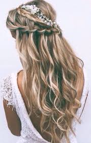 For added panache, you can curl the ends of your hair with a curling iron. Long Curly Hair With A Braid With Flowers Ladystyle