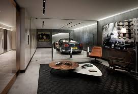 Features gun metal gray cabinets gl custom steel with a butcher block counter top stainless steel pulls and a diamond plate backsplash. Living In A Garage Wie Sieht Ein Luxus Wohnzimmer Stolzer Besitzer Von Sportwagen Aus Freshouse