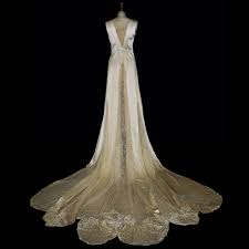 The dress has an asymmetrical neckline with one sleeve and closes in the back with a row of buttons lined in the same fabric. 1920 S Exquisite Silk Satin Lace Bridal Dress Jane Bourvis