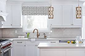 White Shaker Cabinets Accented With A White Quartz Countertop Are Fitted With An Undermount Sink A Copper Kitchen White Quartz Countertop Kitchen Faucet Design