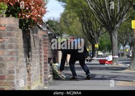 A man leaves a floral tribute