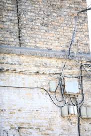 This article series describes brick wall lining or insulation in buildings, why it was used, what problems may occur, and the inspection methods and clues to detect brick lined walls in older homes (sometimes called brick nogging) and discusses the implications of brick wall liners in buildings. Electric Controller Box And Tangle Of Cables On Brick Wall Stock Photos Freeimages Com