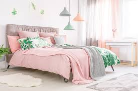 Pink bedroom with a small metal bed complementing the metal shelves racks and desks. 15 Woman Bedroom Ideas