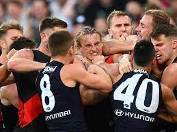 Essendon is hosting carlton at the mcg after bayley fritsch, kysaiah pickett and ben brown helped melbourne to the top of the afl ladder with a win over the winless kangaroos. Tdp2b4lnhrvgrm