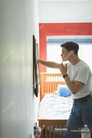 Do not have a mirror facing directly towards the bed. Young Man Applying Face Cream In Front Of Mirror In Bedroom At Home Attractive Casual Clothing Stock Photo 209274270