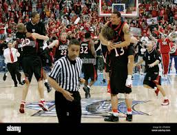New Mexico forward David Chiotti (13) lifts forward Kellen Walter as guard  Blake Harden (25) lifts guard Darren Prentice as the team celebrates their  60-56 win over Utah in the Mountain West