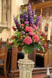 What are you doing to enjoy the birth of spring? At The Aisle End Just Before The Altar Two Dramatic Pedestals Of Deep Purple English Delphin Large Flower Arrangements Large Floral Arrangements Church Flowers