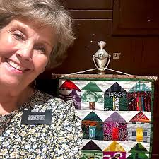 Oh, hey you two! Jenny has been stitching up a storm to brighten up her  space! Just look at that adorable tiny house project she hung