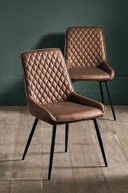 Each arm chair features a metal frame in a luxe gold finish. Pin On Dining Chairs