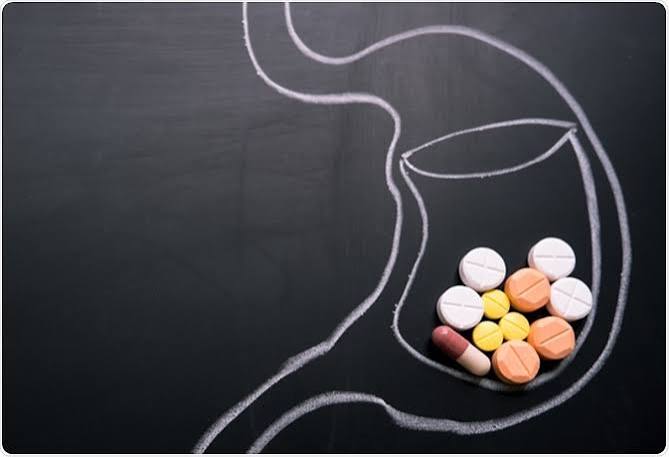 Assortment of medications and a supplement bottle together, illustrating how combining products can change how a medicine is absorbed