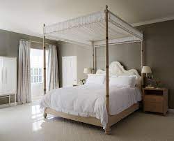 This luxury addition to your bedroom can be enhanced with optional curtain drapes. Light Brown Canopy Bed With Sheer Canopy Transitional Bedroom