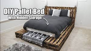 The slatted pallet headboard goes the wall to the wall and gives a charming background to bed along with cool display space. Diy Pallet Bed With Hidden Storage Diy Pallet Bed Pallet Bed Frame Diy Pallet Bed Frame