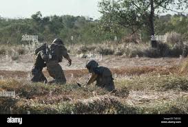 An Armed Forces Of The Philippines Soldier Carries A Notionally Wounded Soldier To A Crew Chief Of A Uh 60 Blackhawk Helicopter April 4 2019 During Medical Evacuation Hoist Training On Fort Magsaysay
