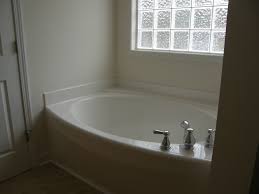 When it comes to home construction and decoration, a garden tub is a. Bathroom Interior Cool Amazing Wall Light Design With Astonishing Glass Block Features White Wall Bath Panels And Bathtub Design Tub Sizes Bathtub Inspiration