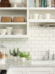 White shaker kitchen cabinets with quartz countertops. Shade Of White Subway Tile Backsplash With White Cabinets