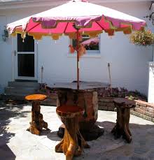 Tree Stump Table With Umbrella And Tree Stump Stools Patio Trees Creative Gardening Patio