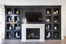 Black And White Fireplace Stunning Black Built In Niche Shelves Surround A White Marble Fireplace Mantel With Interior Black Herri Fireplace Built Ins Fireplace Design Marble Fireplaces