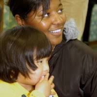 Children who live at Kofu Kodomoen Hoikuen Orphanage watch as U.S. Navy  (USN) MASTER-at-Arms Second Class Tiffany Zandstra, assigned to the  Security Department at Commander Fleet Activities Yokosuka, Japan, loads  her brush