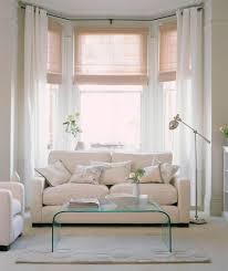 A bay window treatment doesn't have to be difficult or confusing. White Rooms With Style Living Room Windows Living Room White White Rooms