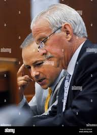 Detroit Police officer Joseph Weekley, left, and his attorney Steve Fishman  confer during a break in the proceedings at the Frank Murphy Hall of  Justice in Detroit Wednesday, June 5, 2013. Weekley