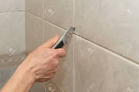 Maybe you would like to learn more about one of these? Male Hands With Knife Removing The Old Grout Replacing Old Grout Stock Photo Picture And Royalty Free Image Image 78023283