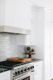 Transitional Kitchen Cooktop Boasts Gray Glazed Wall Tiles Under A White Wooden Range Hood Wit In 2020 Transitional Kitchen Design Transitional Kitchen Kitchen Cooktop