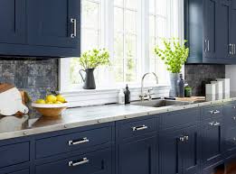 White and navy kitchen features iron and glass cage lanterns over navy center island accented with x trim moldings topped with white and gray stone countertops lined with restoration hardware tractor seat barstools. Navy Kitchen Ideas Photos Houzz