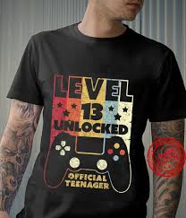 Vintage style graphic design gift for son or daughter who became teenager this year . Level 13 Unlocked Official Teenager Shirt